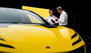 Auto Express editor-at-large Phil McNamara standing next to a Lotus Emeyal